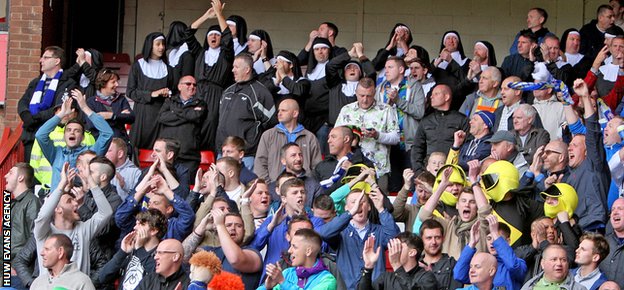 Cardiff 's travelling fans cheer on their team at Nottingham Forest