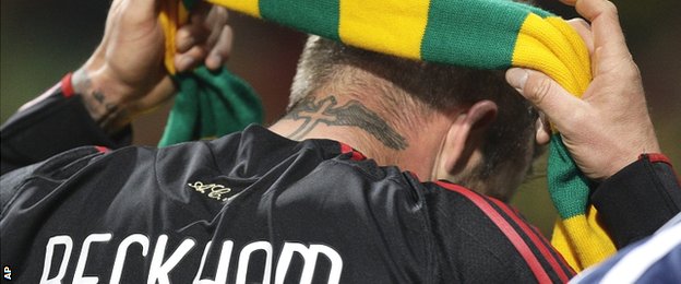 David Beckham puts on a green and gold scarf to show his support for Man Utd fans on his return to Old Trafford with Real Madrid in 2010