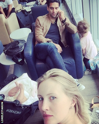 Radamel Falcao and his wife Lorelei Taron and their two children in an airport departure lounge