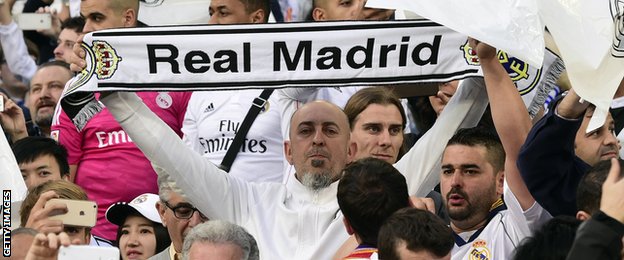 Real Madrid fans hold scarves