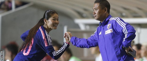 Homare Sawa embraces coach Norio Sasaki during a World Cup warm-up game.