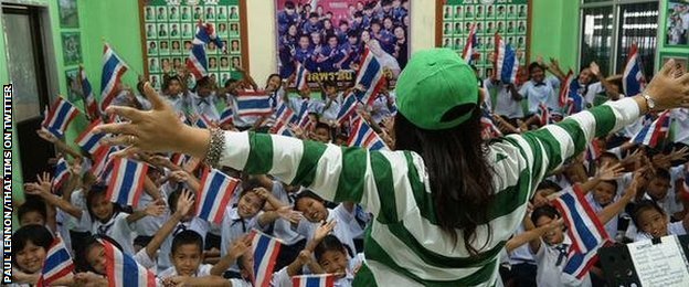 Schoolchildren in Thailand learn a song to support their team at the World Cup