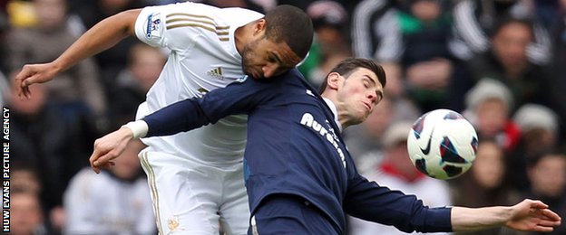 Ashley Williams beats Gareth Bale to the ball during a match between Tottenham and Swansea