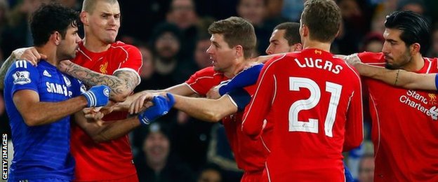 Diego Costa held back from a frustrated Steven Gerrard after an altercation with Emre Can